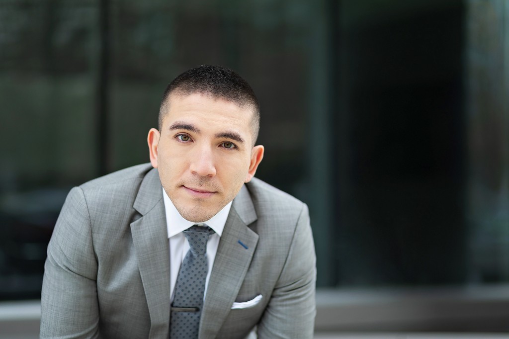 Adam Naamani in business attire.